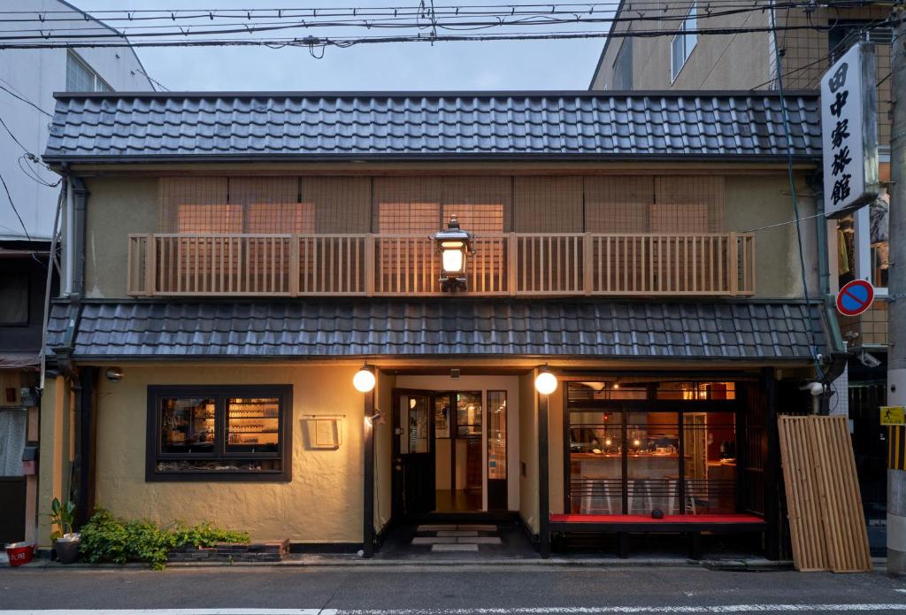 a building with a balcony on top of it at HOTEL Clam Chowder in Kyoto