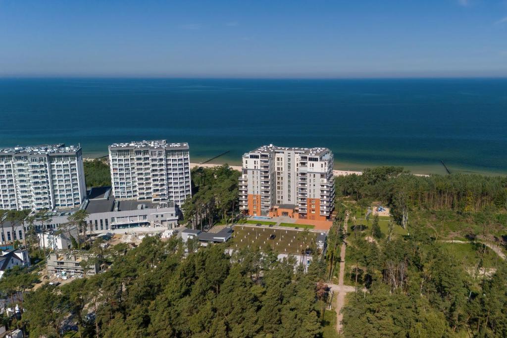an aerial view of a city with tall buildings and the ocean at Apartamenty Porta Mare by Renters in Dziwnówek