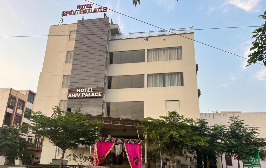 a building with pink curtains in front of it at HOTEL SHIV PALACE in Jaipur