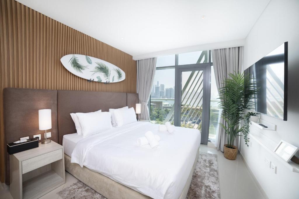 a bedroom with a large white bed and a large window at Signature Studio Full Sea View on Palm Jumeirah in Dubai