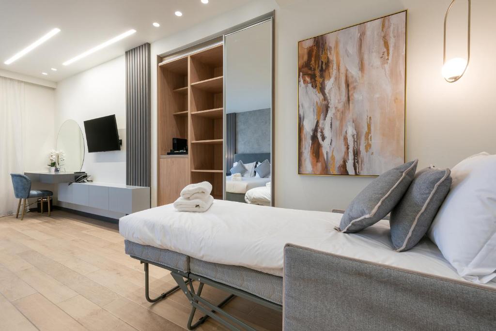a bedroom with a large bed and a bathroom at GRAND PATELLI in Myrina