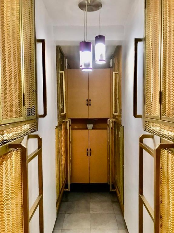 a hallway with yellow doors and windows in a building at Budget Transient Capsule Room Mirasol Near BGC in Manila