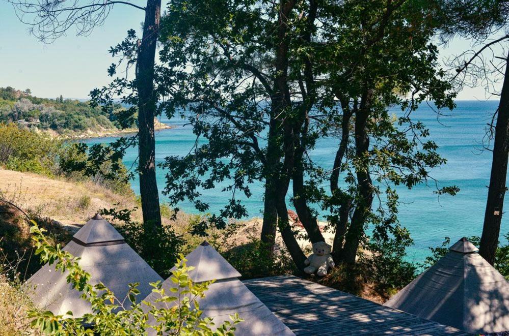 a view of a body of water with trees and tents at Ecoclub in Varna City