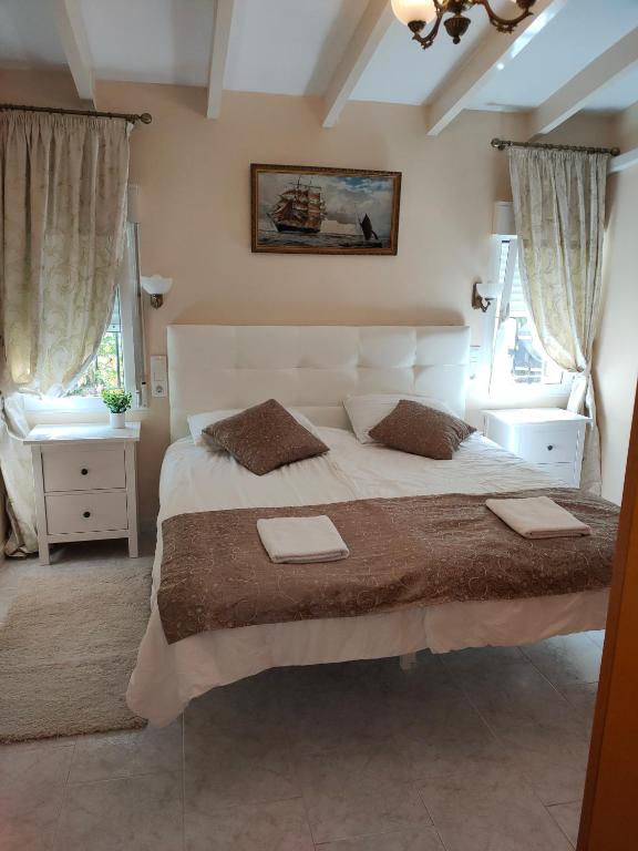 a bedroom with a large white bed with two pillows at Apartments in a "VILLA VISTA JAVEA" in Jávea