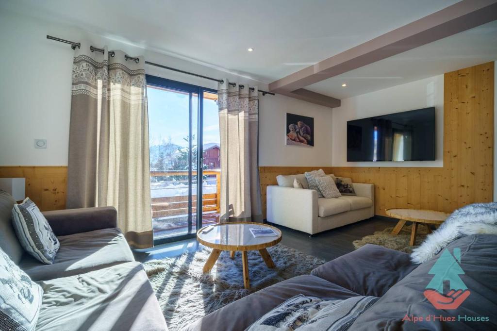 ラルプ・デュエズにあるAlpe d'Huez Houses - Chez Stella - 3 chambres neuf plein centreのソファとテーブルのあるリビングルーム