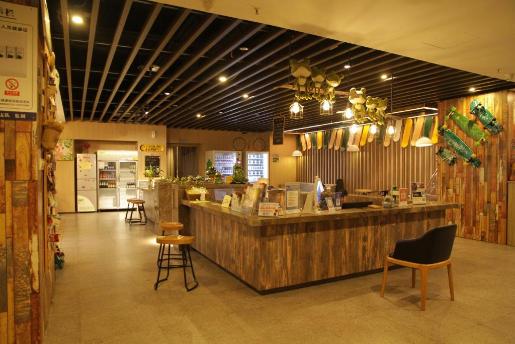 a restaurant with a counter and chairs in a room at Heye International Youth Hostel in Chongqing