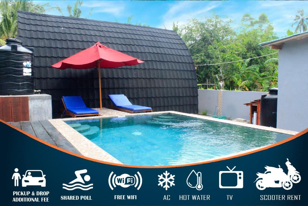 a swimming pool with two chairs and an umbrella at Sekar Kuning Cottage in Toyapakeh