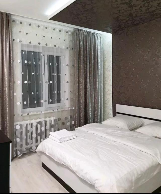 a bedroom with two beds and a window at Кылышбай акына in Taraz