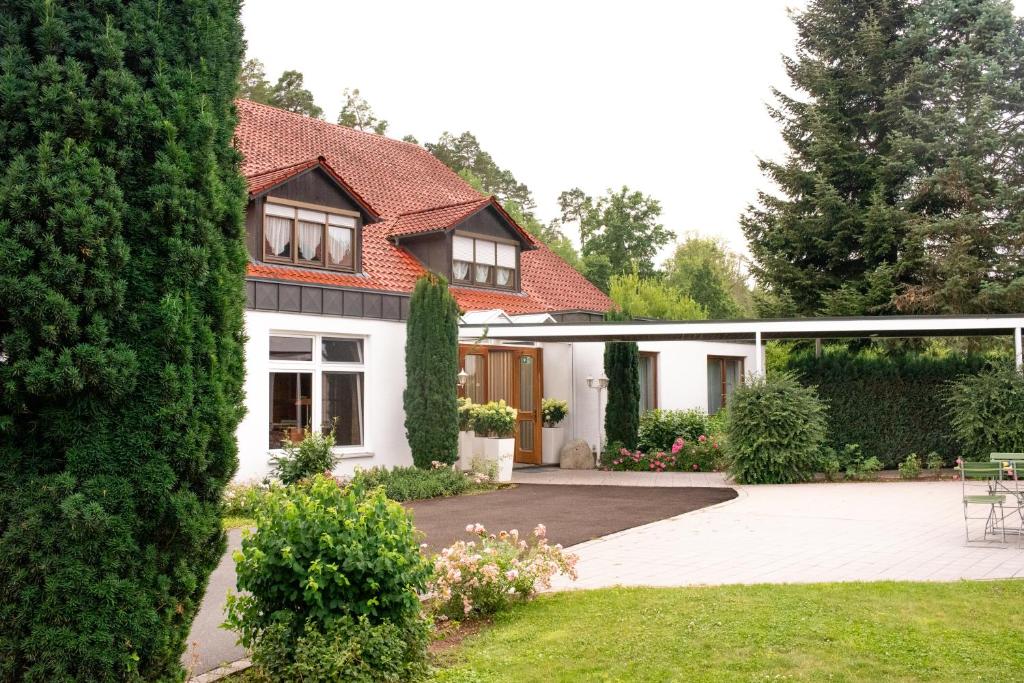 a house with a courtyard and a garden at Hotel Restaurant Moosmühle in Dietenhofen