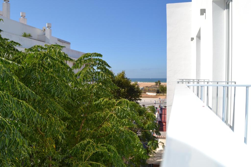 a view from the balcony of a white building at Hotel OASIS CENTRO in Conil de la Frontera