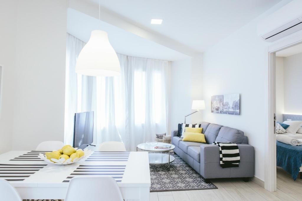 a white living room with a couch and a table at The Lucky Flats - Poeta Quintana in Alicante