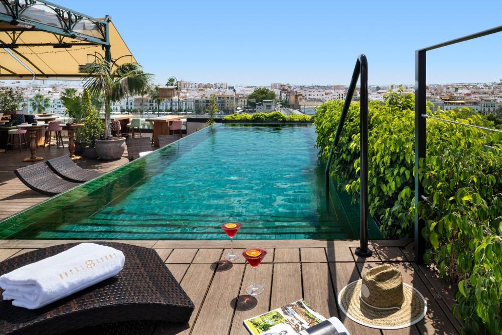 a swimming pool on top of a building at Hotel Lobby in Seville