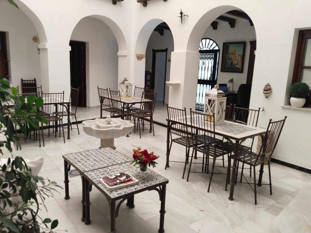 a group of tables and chairs in a room at Hostel Mayflowers in Córdoba