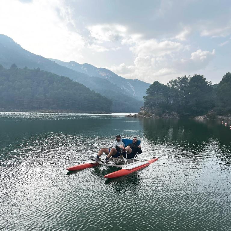 two people sitting on a paddle boat in the water at Moli l&#39;Abad in Puebla de Benifasar