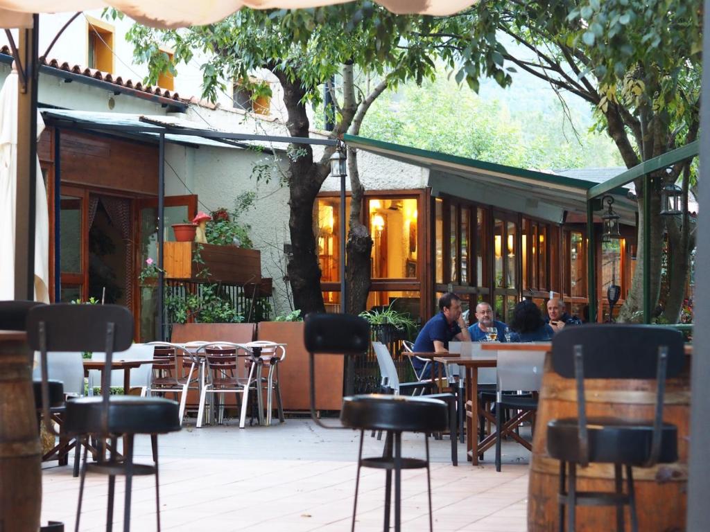 a group of people sitting at tables in a restaurant at Moli l&#39;Abad in Puebla de Benifasar