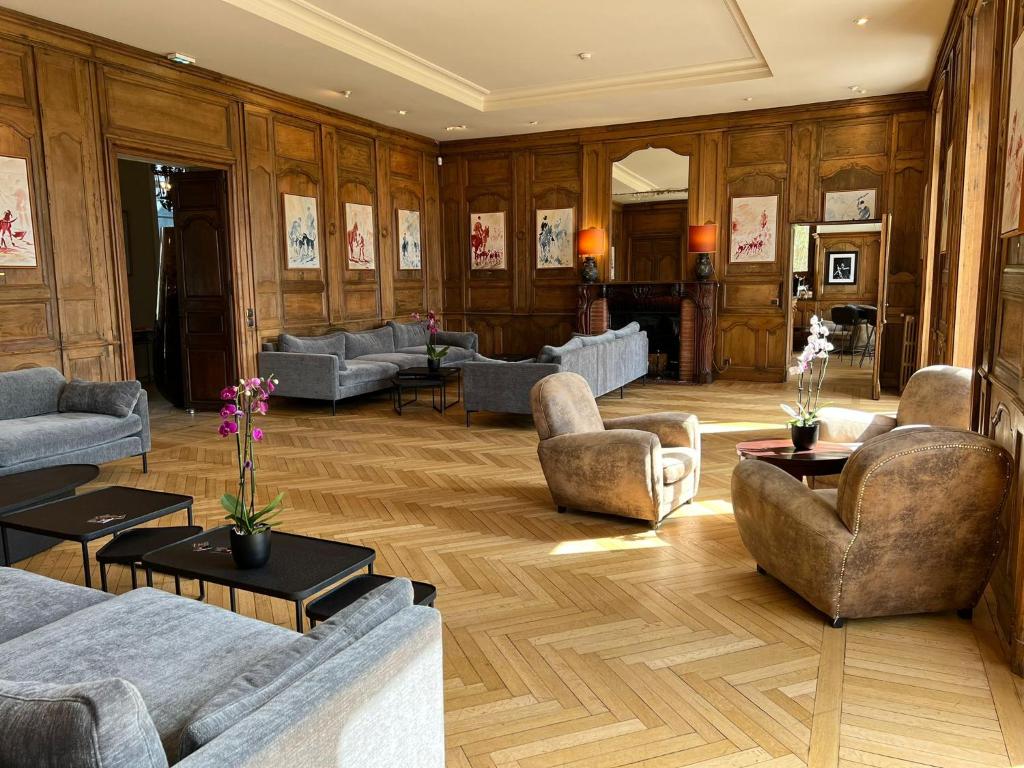 a large living room with couches and tables at Hôtel Villa Navarre in Pau