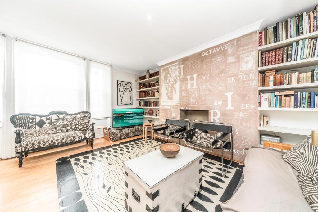 a living room with a brick wall at Chic Top Floor Apartment in the heart of Notting Hill Ladbroke Grove in London