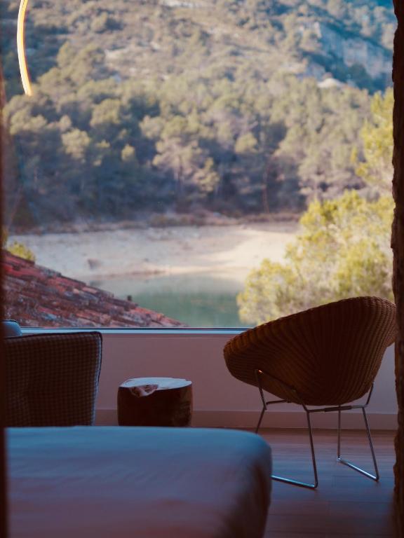 a room with a large window with a table and chairs at Moli l&#39;Abad in Puebla de Benifasar