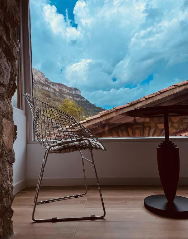 a chair in front of a window with a view at Moli l&#39;Abad in Puebla de Benifasar