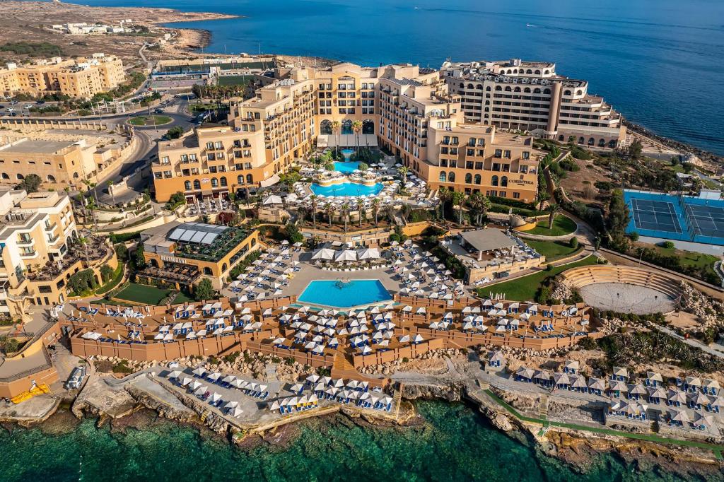 an aerial view of a resort with a swimming pool at Corinthia Hotel St. George’s Bay in St Julian's