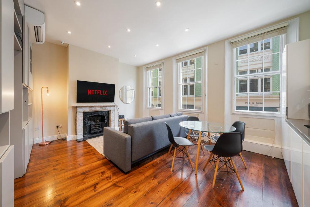 a living room with a couch and a table at Superb One Bedroom Apartment in Soho in London