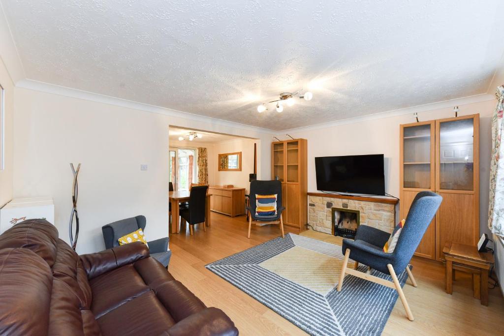 a living room with a couch and a fireplace at Lambourne House in Nottingham