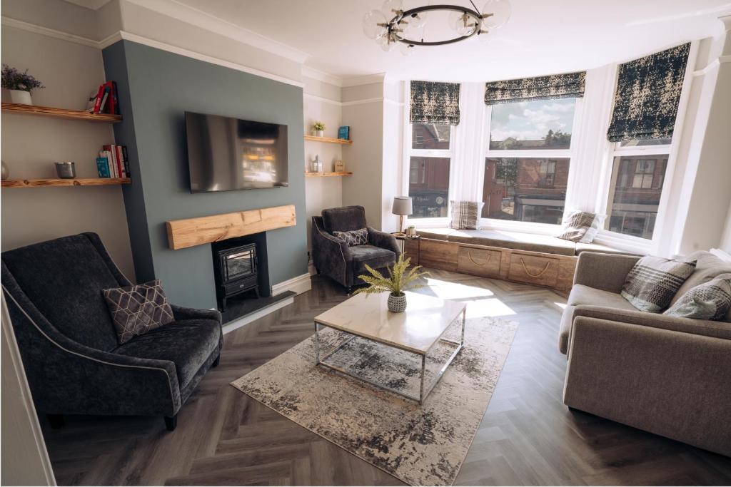 a living room with a couch and chairs and a table at The Dunes, Lytham St Annes in Lytham St Annes