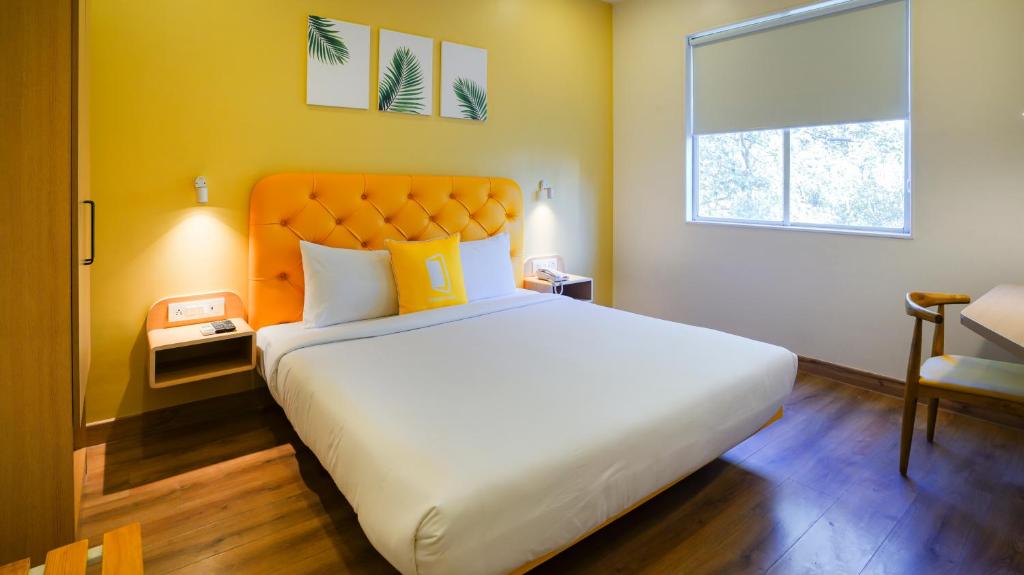 Postel nebo postele na pokoji v ubytování Bloom Hotel - Magarpatta