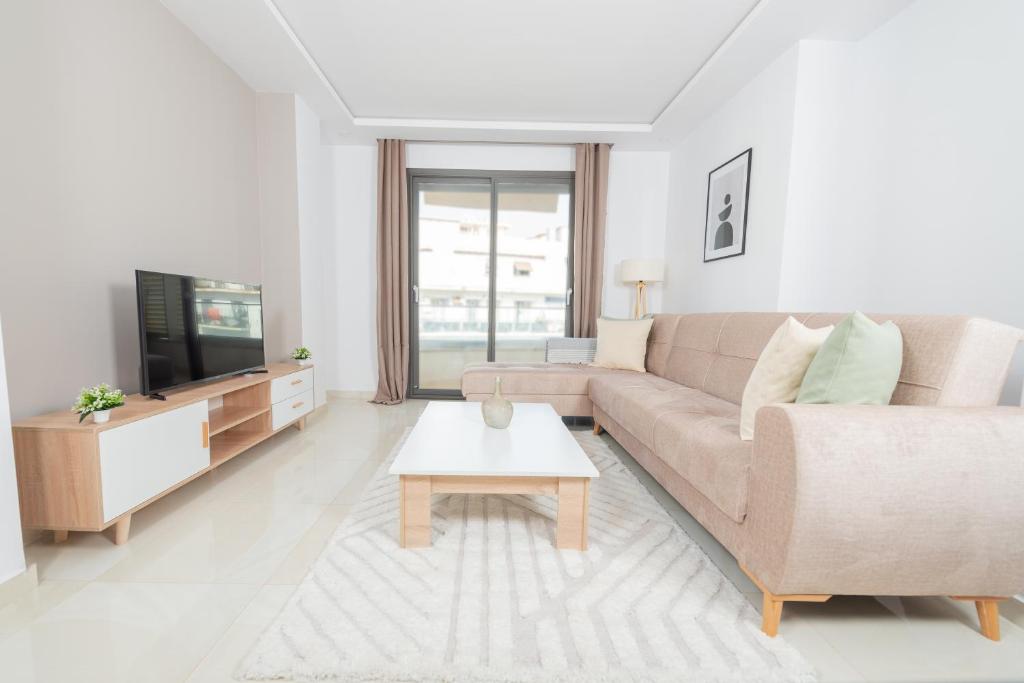 a living room with a couch and a tv at Appartement Luxueux à Kouba in Kouba