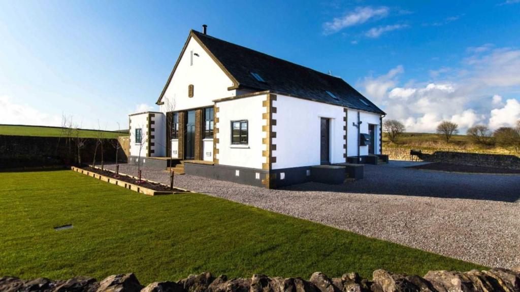 a white house with a black roof at The Telephone Exchange at Parsley Hay in Buxton
