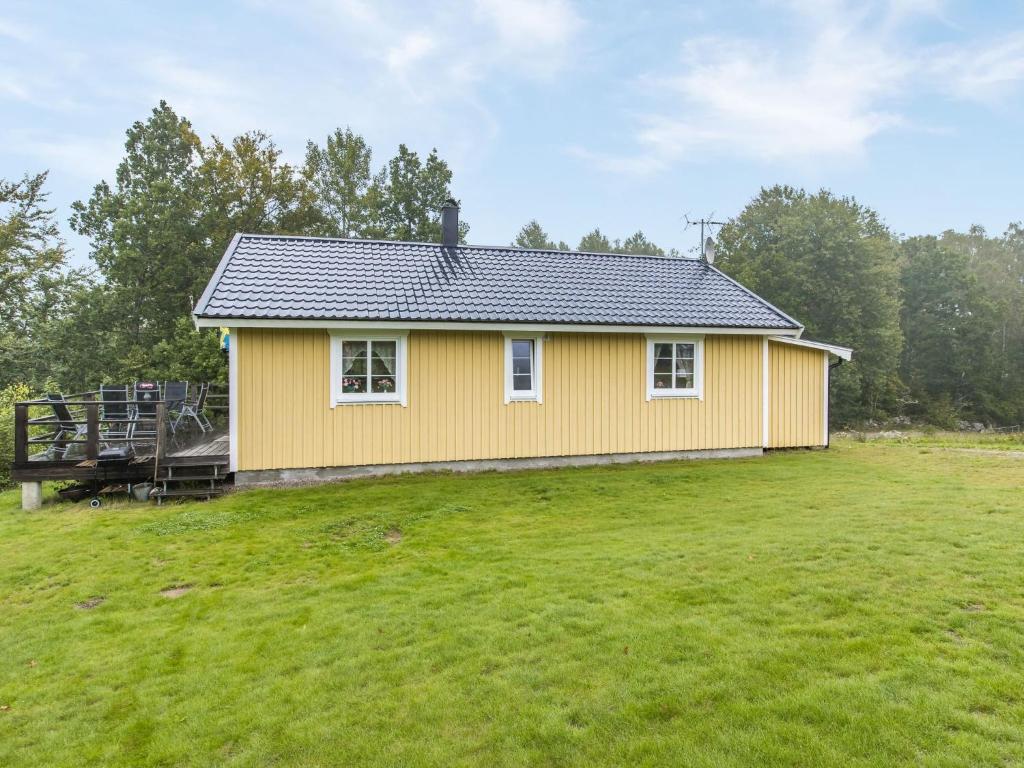 a yellow house with a large grassy yard at Holiday Home Gaslunda - B in Olofström