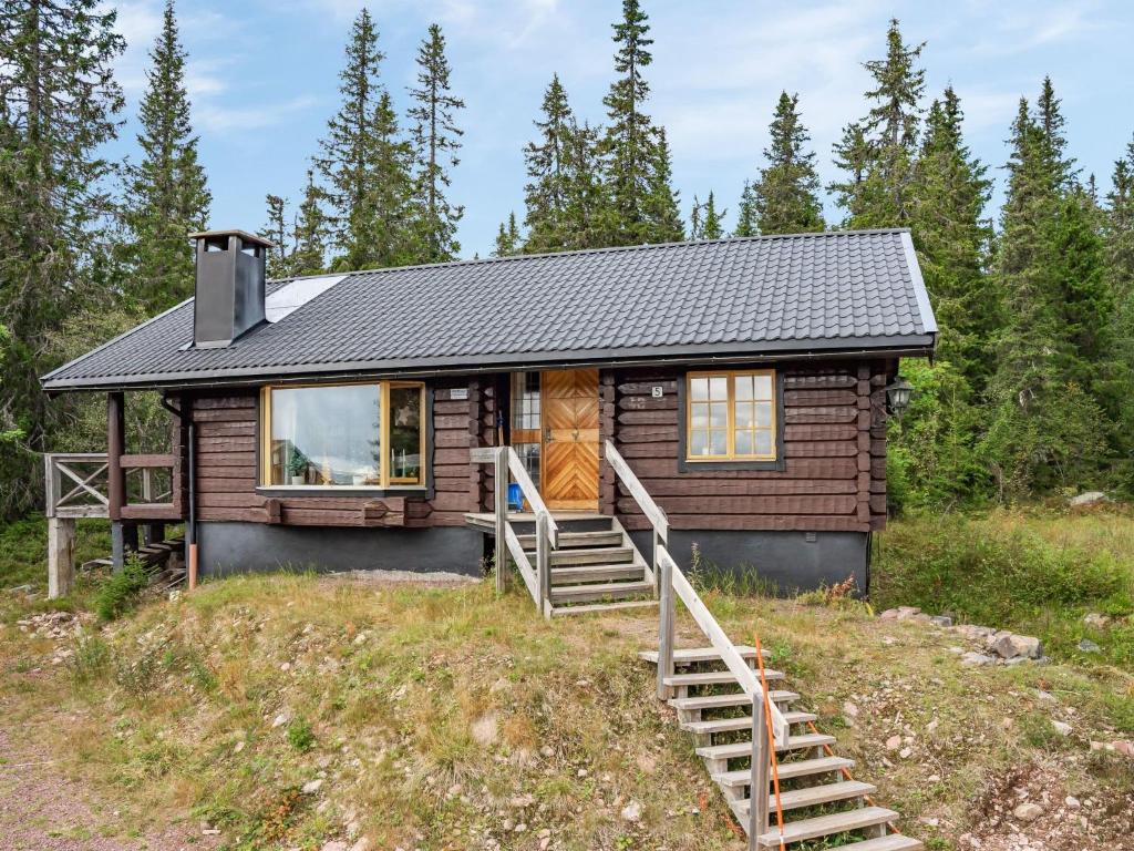 ein winziges Haus auf einem Hügel im Wald in der Unterkunft Chalet Korpstigen Älgen - DAN075 by Interhome in Sälen