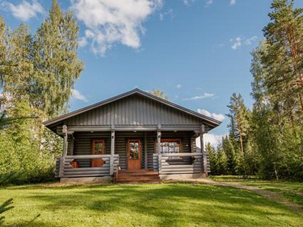 a small wooden house with a large yard at Holiday Home Marttalanmäki by Interhome in Valittula