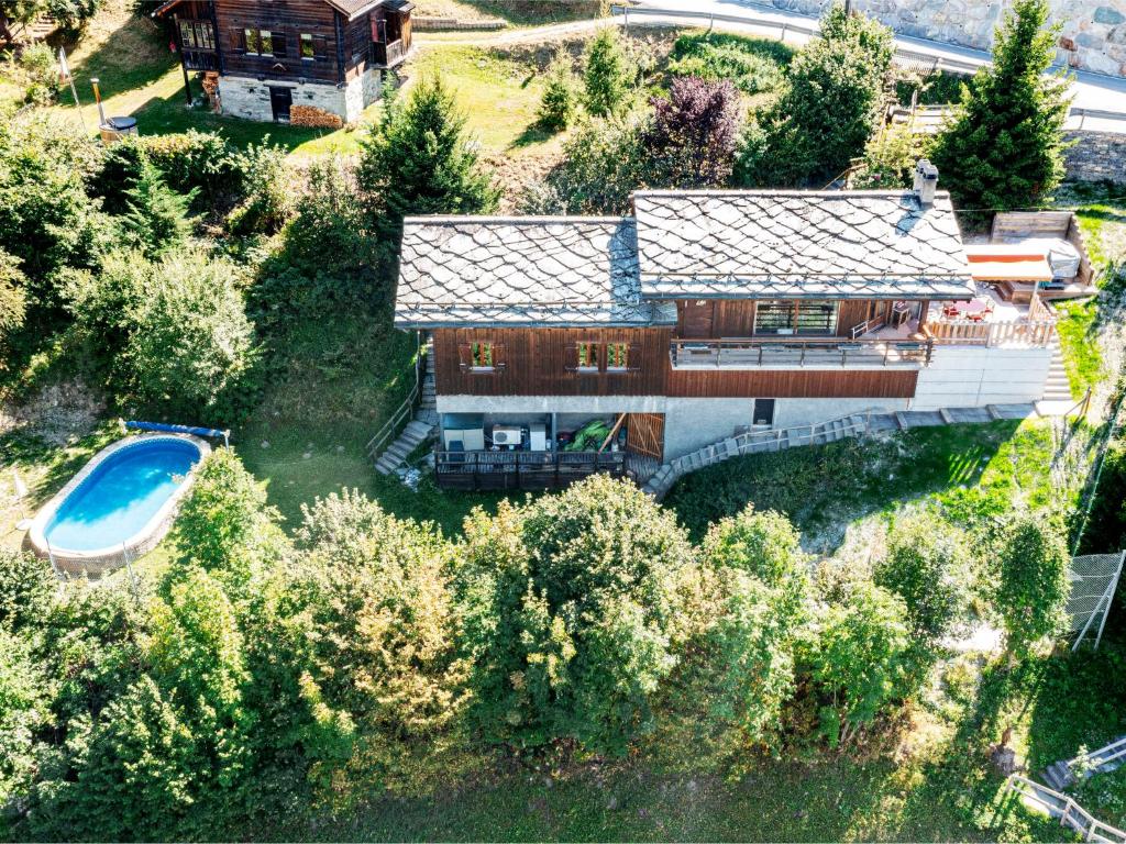 an aerial view of a house with a swimming pool at Chalet Chalet Mayens by Interhome in Agettes
