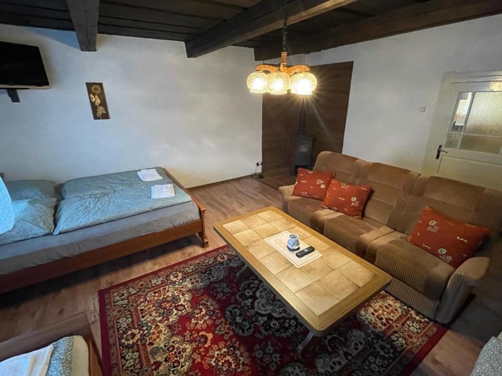 a living room with a couch and a coffee table at Chalupa Sofia - celý objekt in Vikartovce