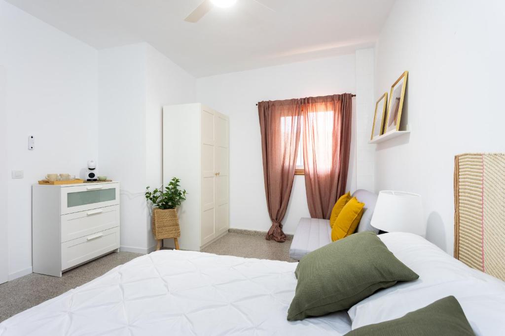 a bedroom with a white bed and a window at EDEN RENTALS B01 Surfy Stylish Bed&Coffee Room in Granadilla de Abona