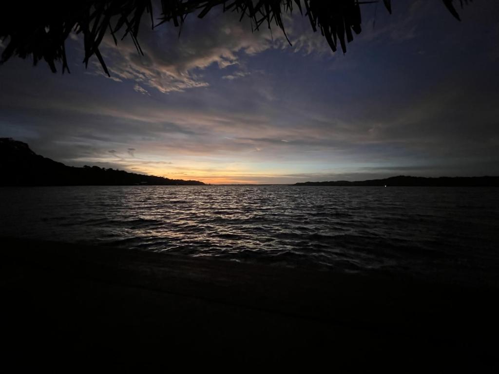 a sunset over a large body of water at Akwaba Lodge in The Gap