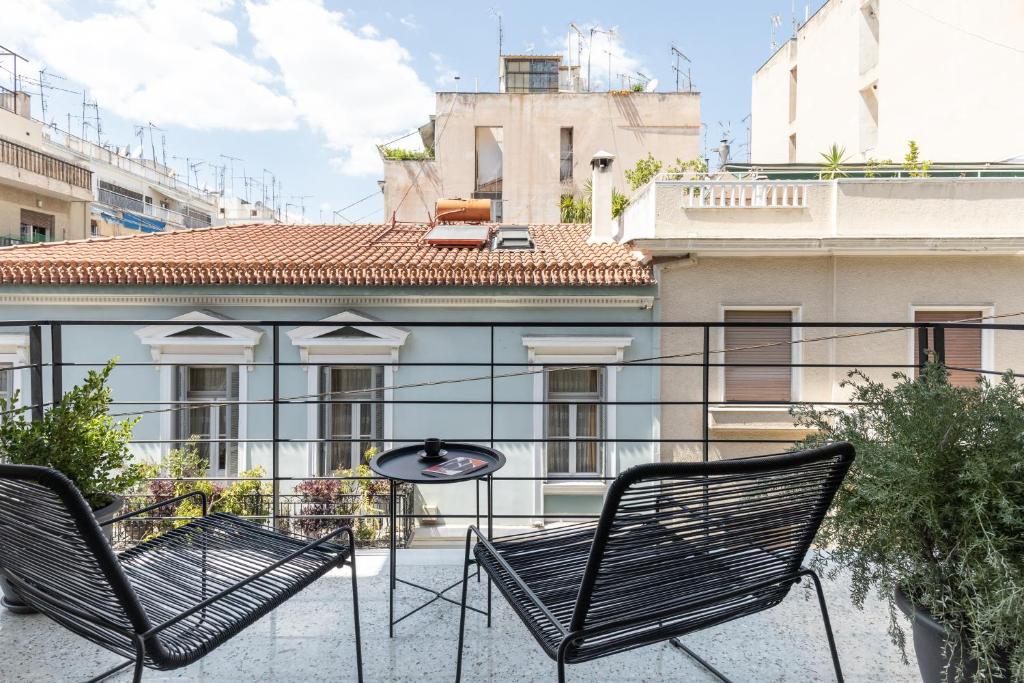 2 stoelen en een tafel op een balkon bij Elliot in Athene