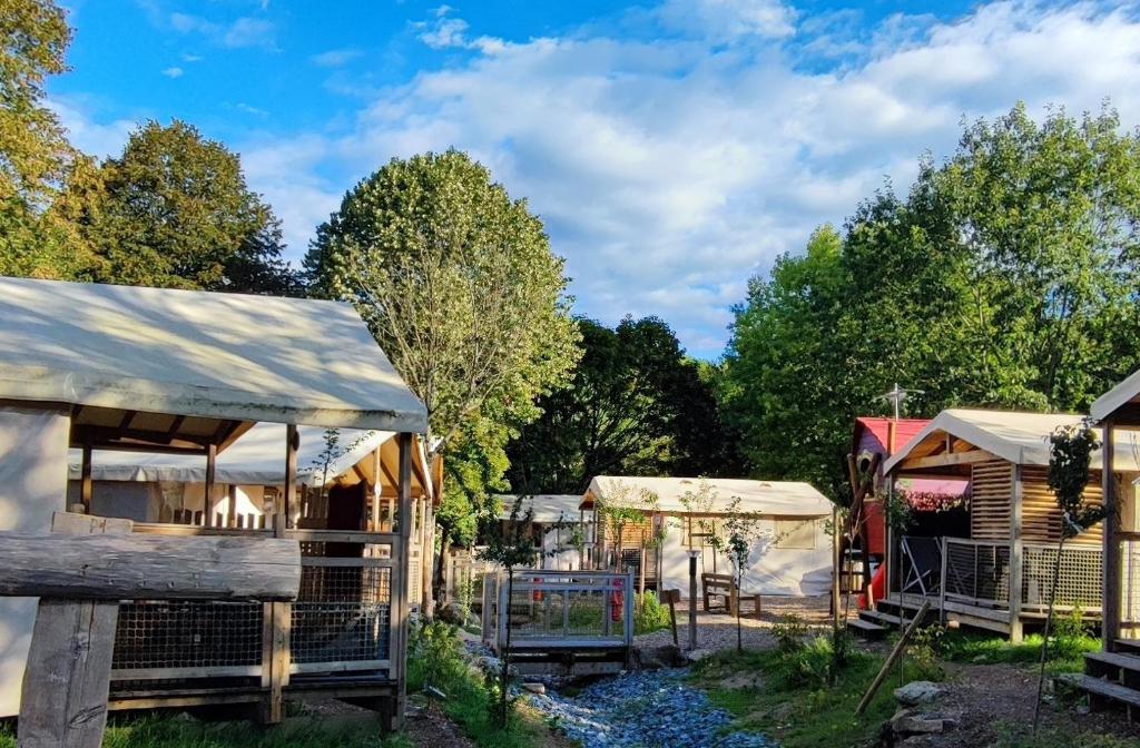 a garden with houses and trees in the background at Camping Capfun La Bretèche in Les Épesses