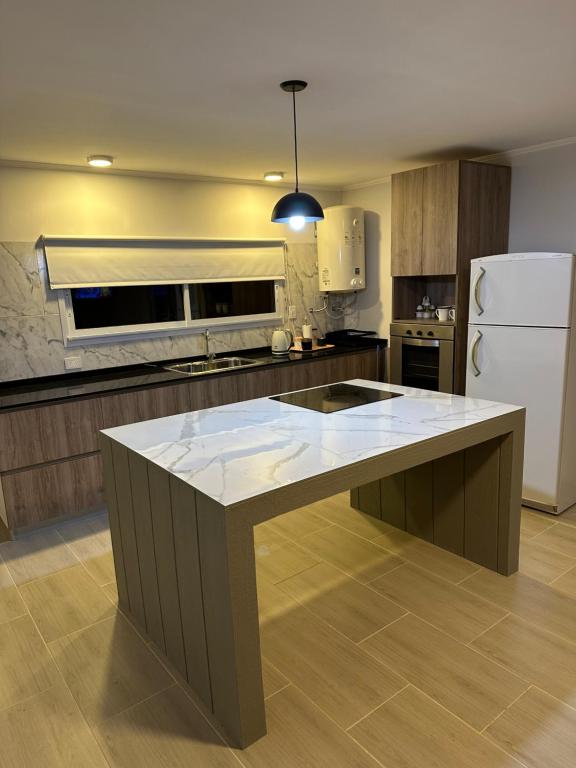 Una cocina con una gran isla en el medio. en Casa barrio cerrado Las Lomas, en Monte Hermoso