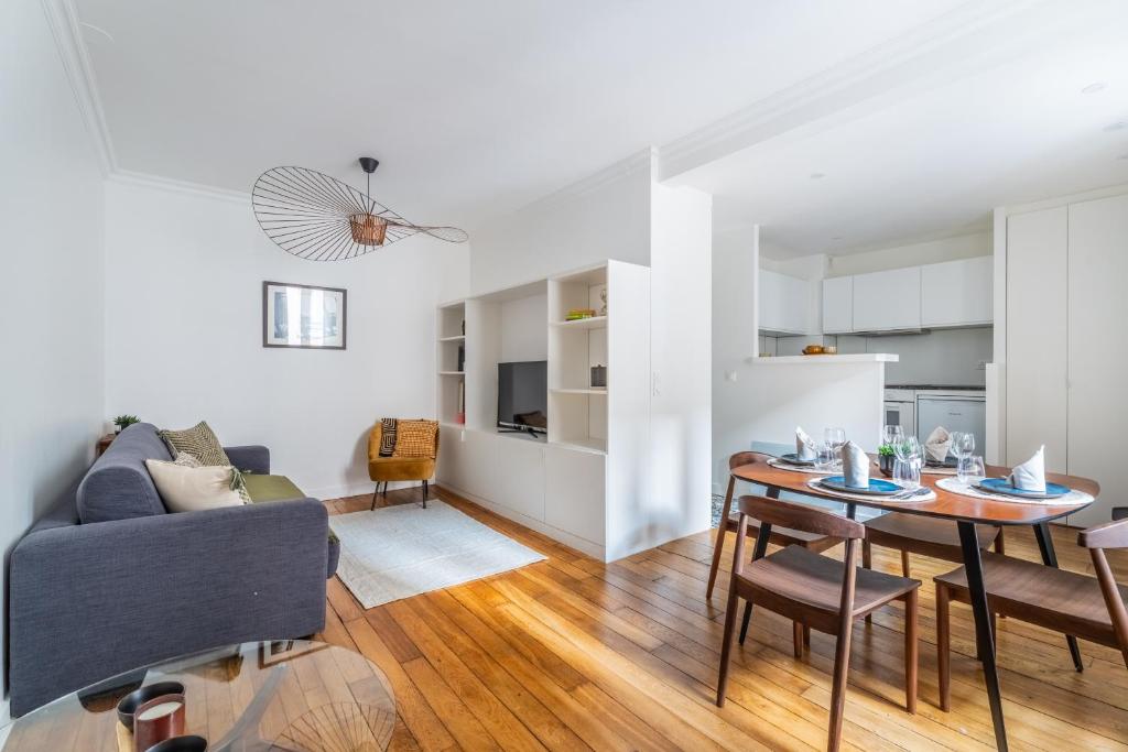 a living room with a table and a couch at Cozy flat Paris centre in Paris