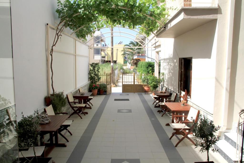 an internal courtyard of a restaurant with tables and chairs at Hotel Stella in Volos