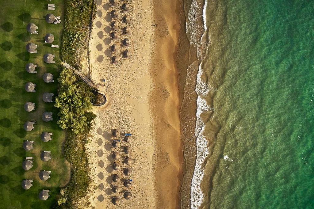 an overhead view of a beach with tents and the ocean at ROBINSON KYLLINI BEACH - All Inclusive in Kyllini