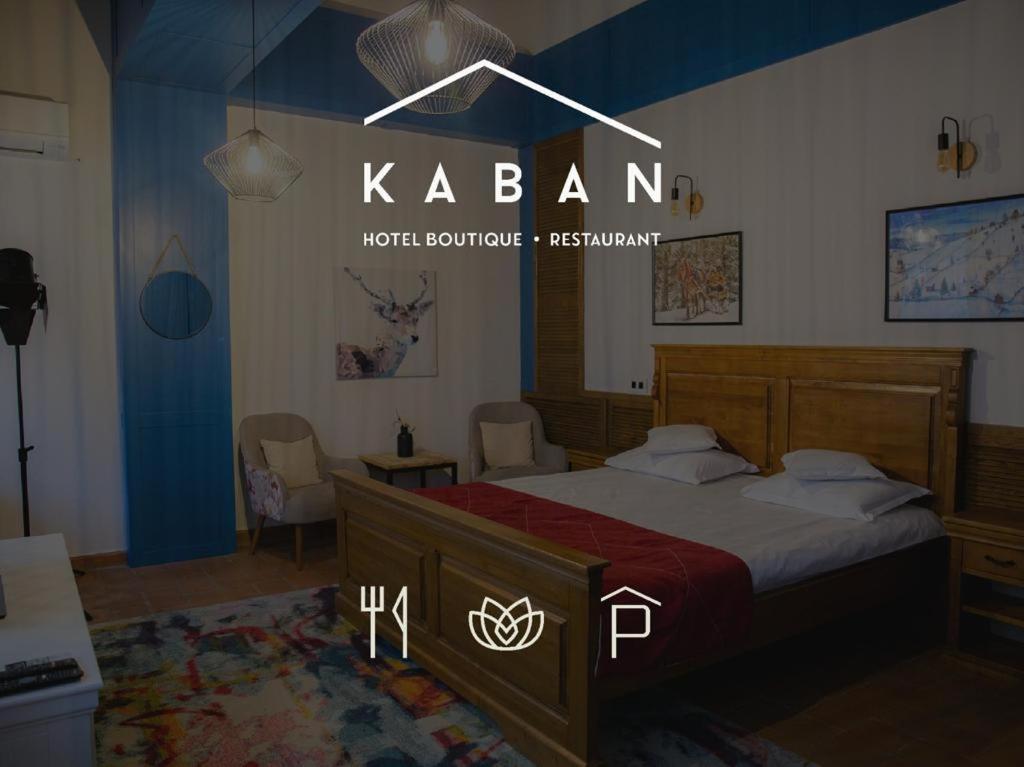 a bedroom with a bed with a red blanket at KABAN Boutique in Vatra Dornei