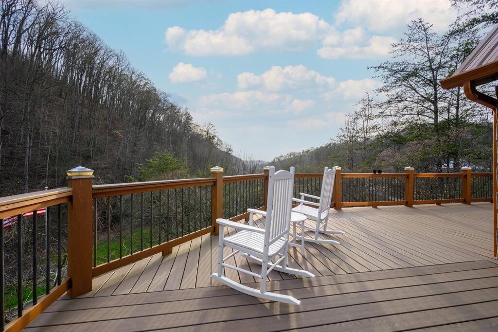 two white chairs sitting on a wooden deck at Secluded Cabin / Stunning Mtn View / Paved Drive in Sevierville
