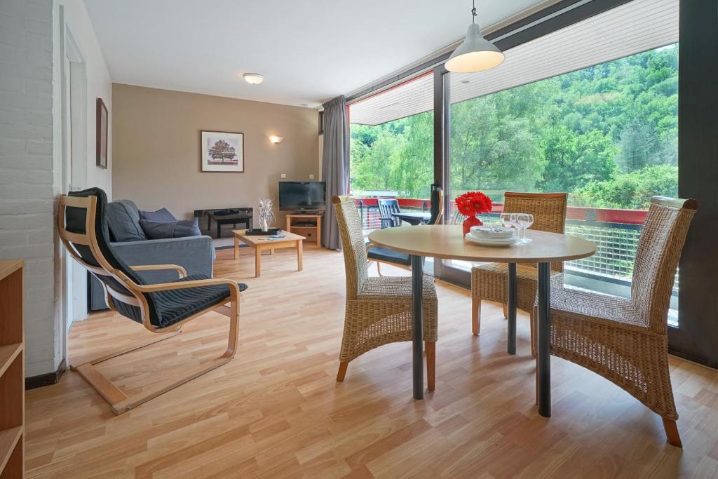 a living room with a table and chairs at Domaine Long Pre in Stavelot