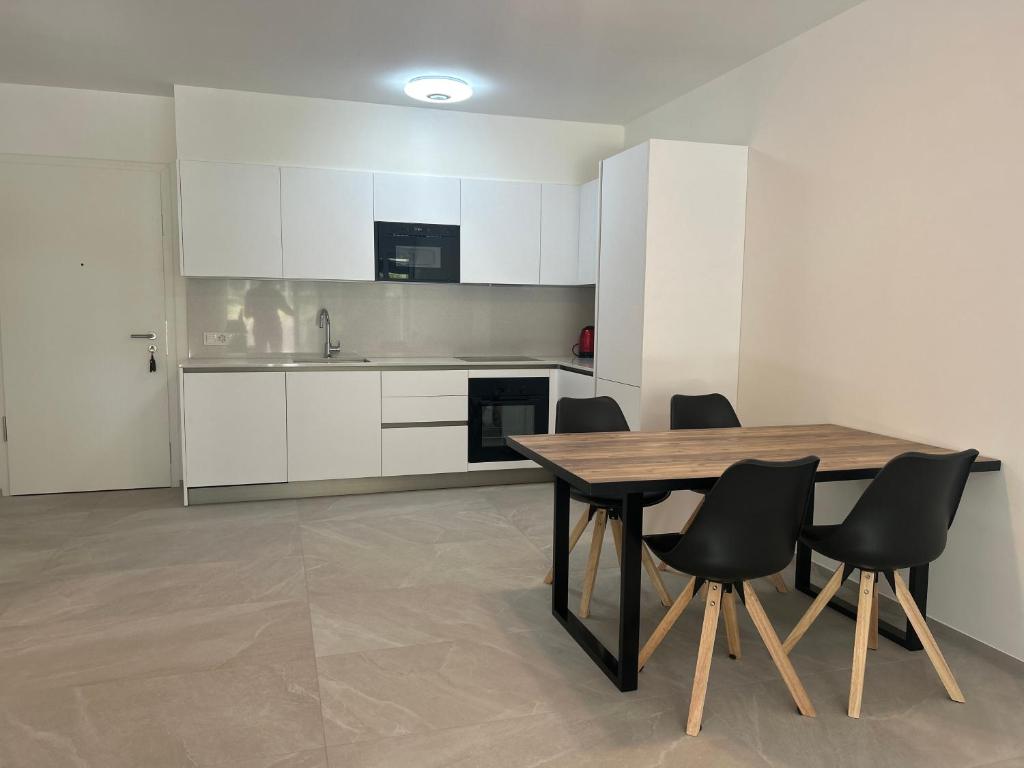 a kitchen and dining room with a table and chairs at Contemporary Apartment Ticino in Mendrisio