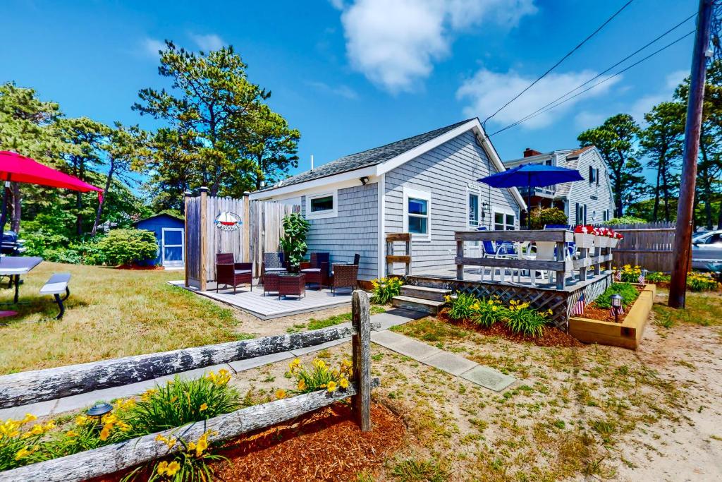 a house with a yard with a patio at Captain Rich in Dennis Port