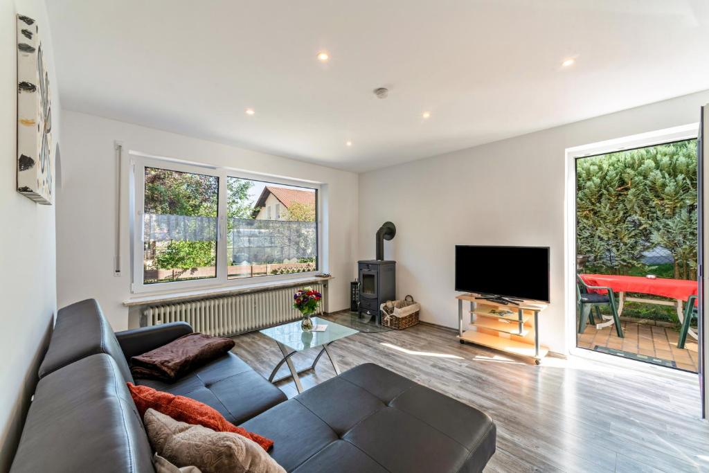 a living room with a couch and a flat screen tv at Ferienwohnung Burmeister in Nittenau