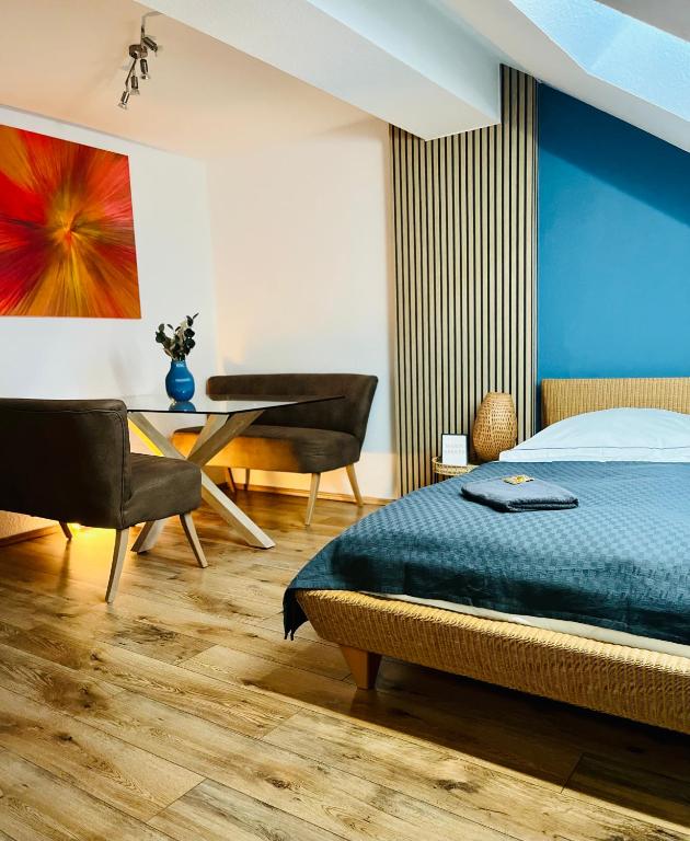 a bedroom with a bed and a table and a piano at AyCatcherHomes - Sirius I Old Town I 2BR I 4 Guests in Marburg an der Lahn